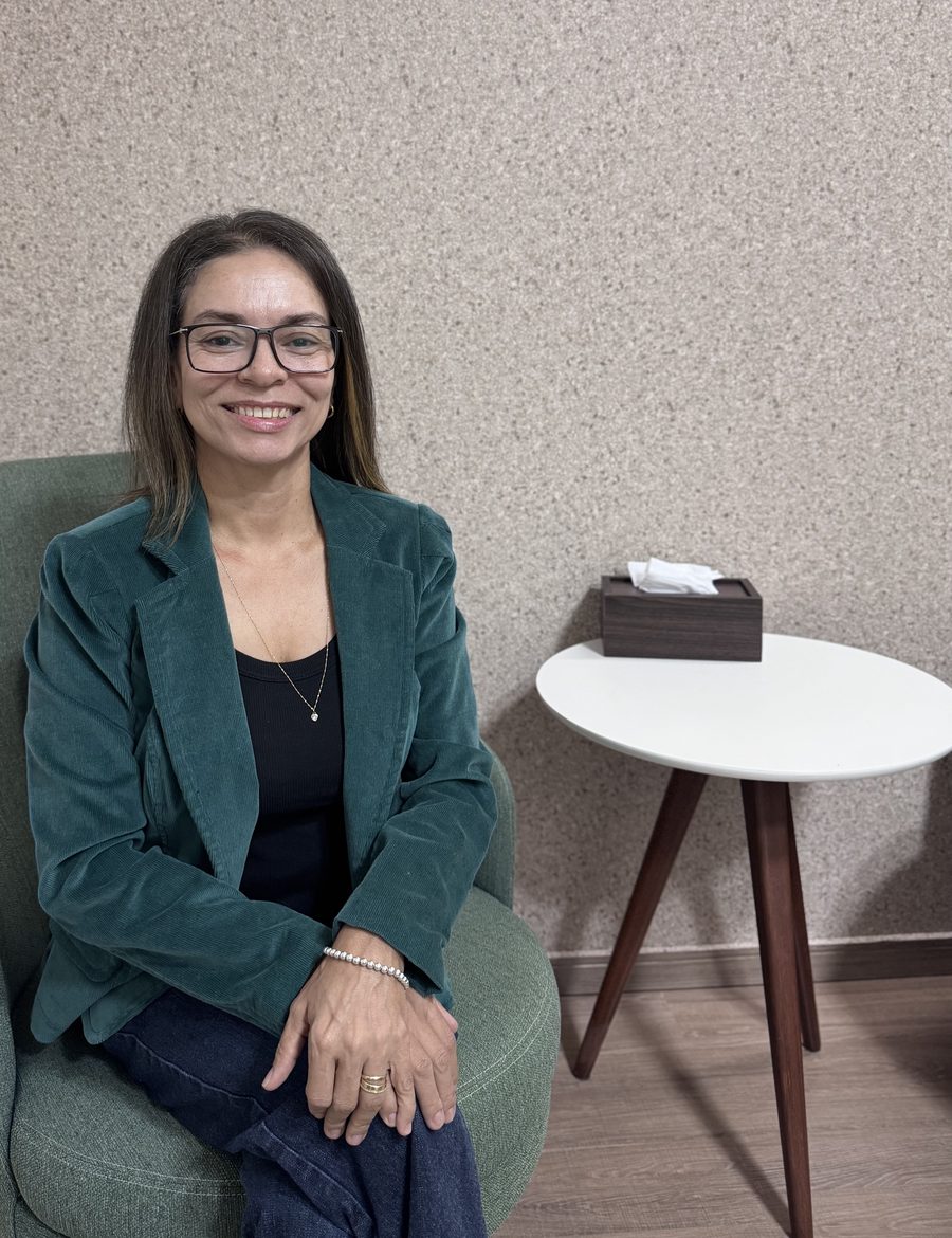Sandra Menezes, psicóloga, sentada em uma poltrona no consultório